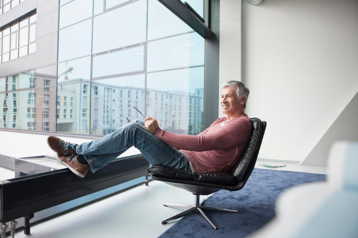 Man relaxing in a leather chair at home
